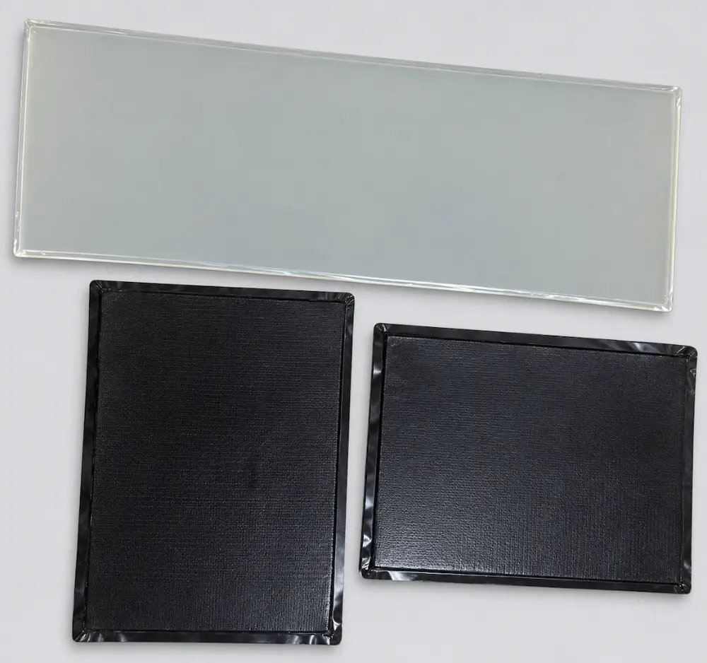 Film-laminated aerogel thermal barrier pads with heat-sealed edges for battery energy storage modules