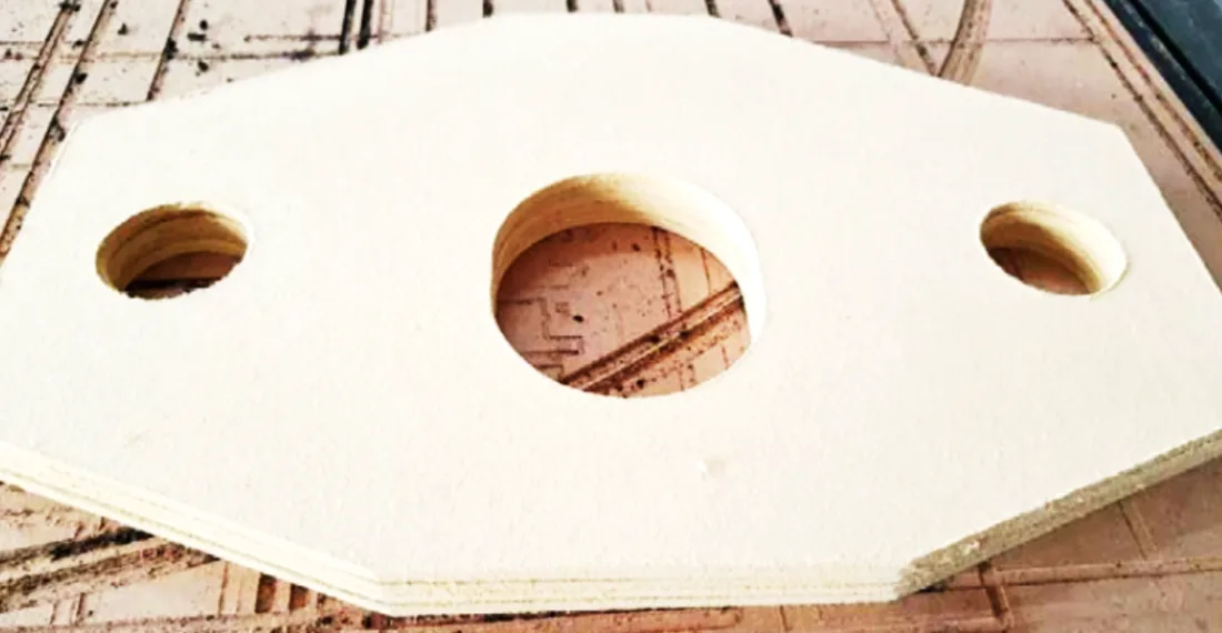 CNC-cut insulation board gasket with three holes — Wedge millboard machined to drawing