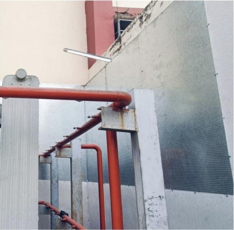 Perforated steel composite fire and blast wall panels installed behind transformer radiators and fire-water piping